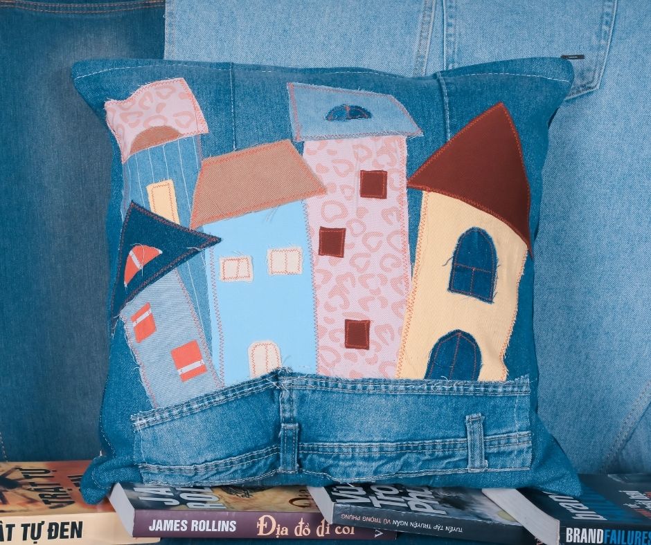 Recycled denim patchwork cushion depicting an old town